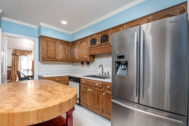 kitchen featuring appliances with stainless steel finishes, decorative backsplash, an inviting chandelier, ornamental molding, and sink