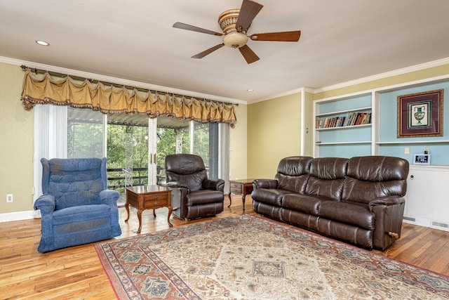 living room featuring ceiling fan, crown molding, and wood-type flooring