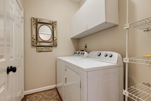 laundry area featuring cabinets and separate washer and dryer