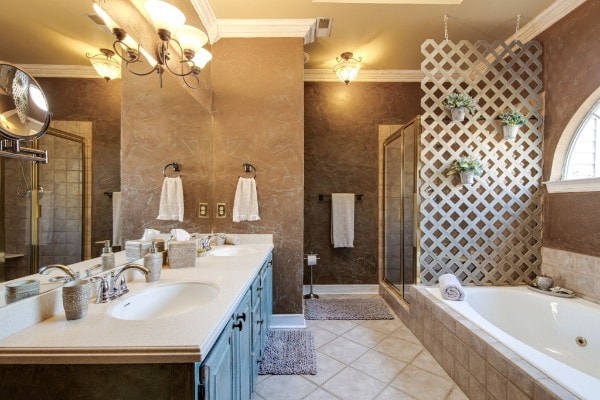 bathroom featuring vanity, tile patterned flooring, an inviting chandelier, plus walk in shower, and ornamental molding