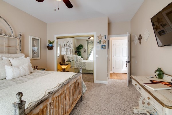 carpeted bedroom featuring ceiling fan and a closet