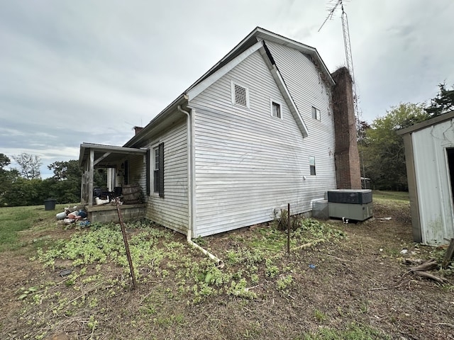 view of side of home with central AC unit