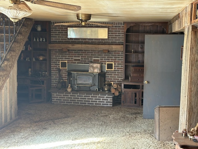 unfurnished living room with carpet flooring and a wood stove