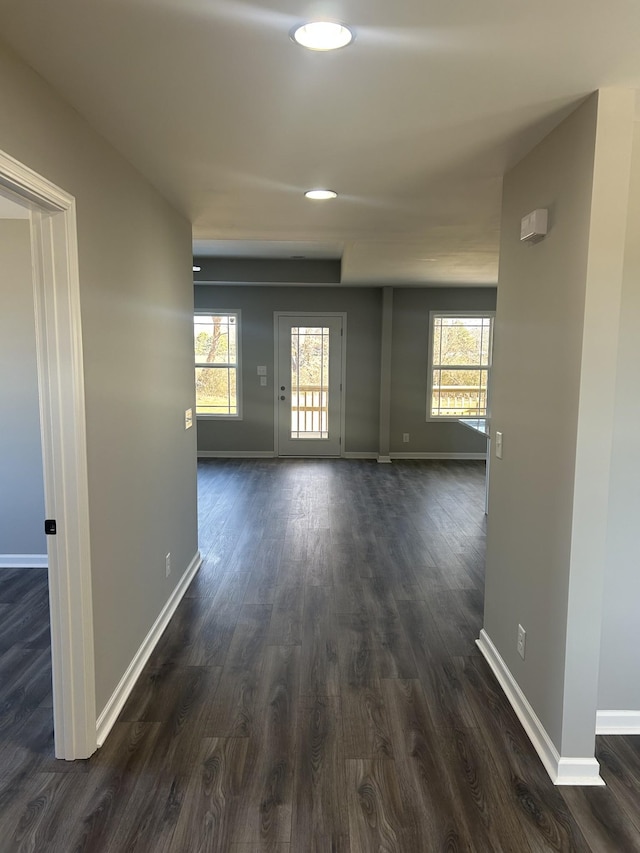 hallway with dark hardwood / wood-style flooring