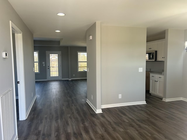 hallway with dark hardwood / wood-style flooring