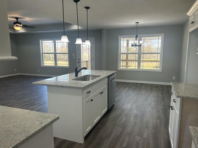 kitchen featuring sink, a center island with sink, and white cabinets