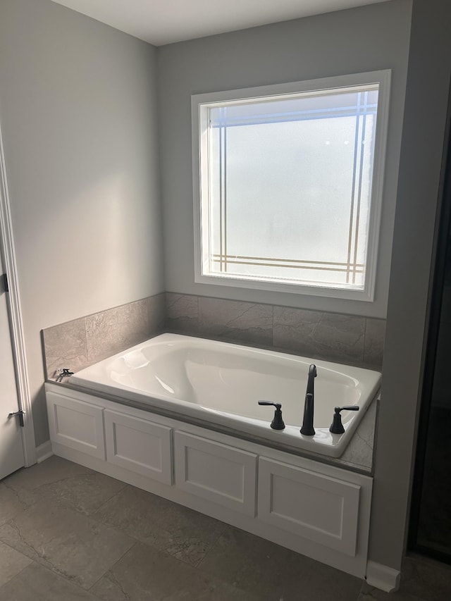 bathroom with a healthy amount of sunlight and a bathtub