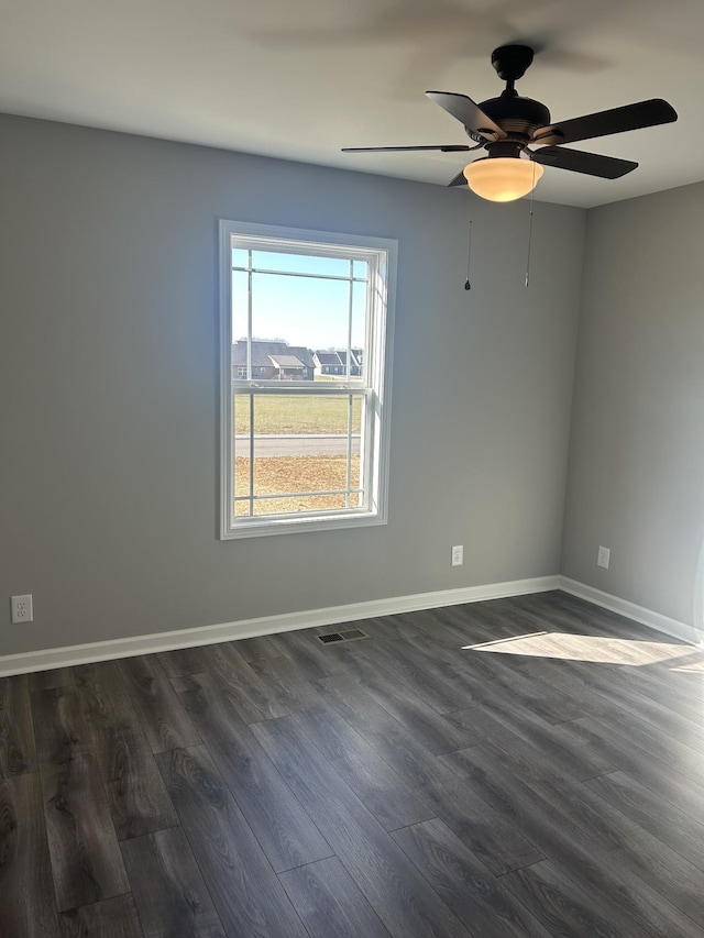 empty room with ceiling fan and dark wood-type flooring