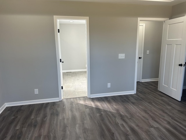 unfurnished bedroom featuring dark hardwood / wood-style flooring