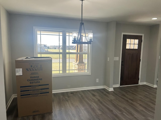 foyer entrance featuring a notable chandelier and dark hardwood / wood-style flooring