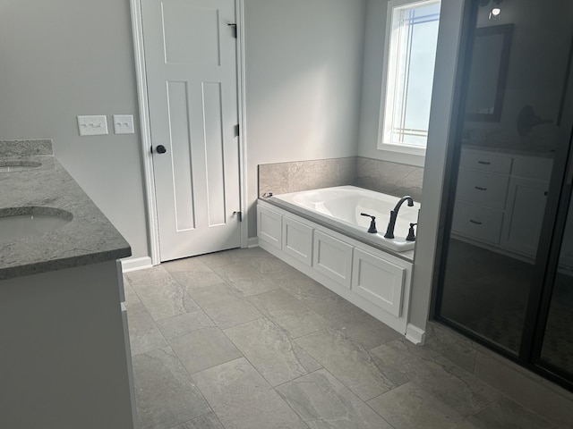 bathroom featuring vanity and a tub