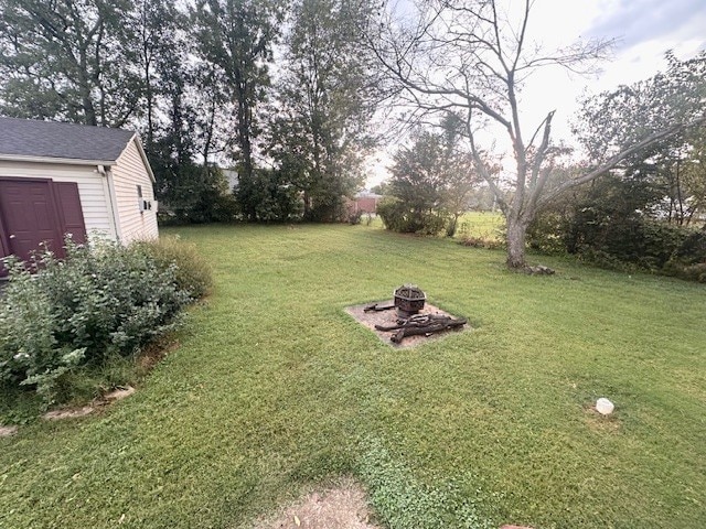 view of yard with an outdoor fire pit