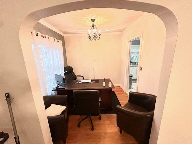 office area featuring wood-type flooring, an inviting chandelier, and crown molding