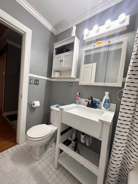 bathroom with ornamental molding, tile patterned flooring, and toilet