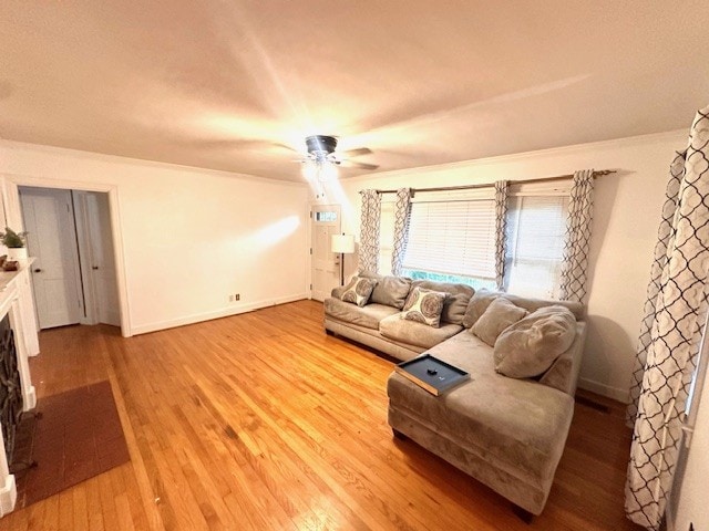 living room featuring ceiling fan, hardwood / wood-style flooring, and ornamental molding