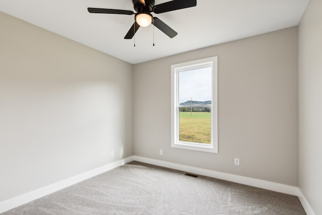 spare room featuring carpet and ceiling fan