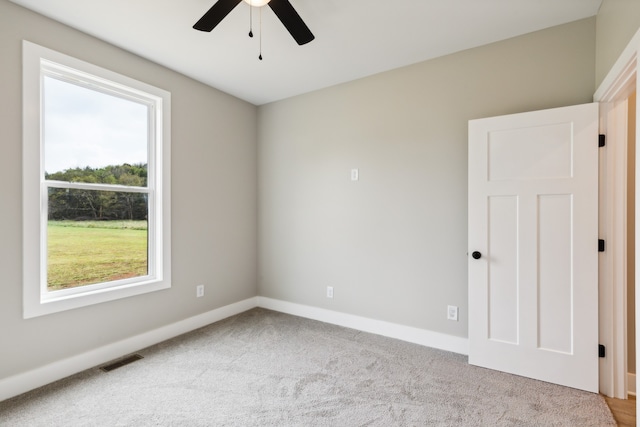 carpeted empty room with ceiling fan