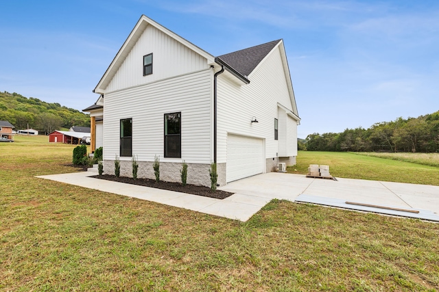 view of property exterior with a yard and a garage