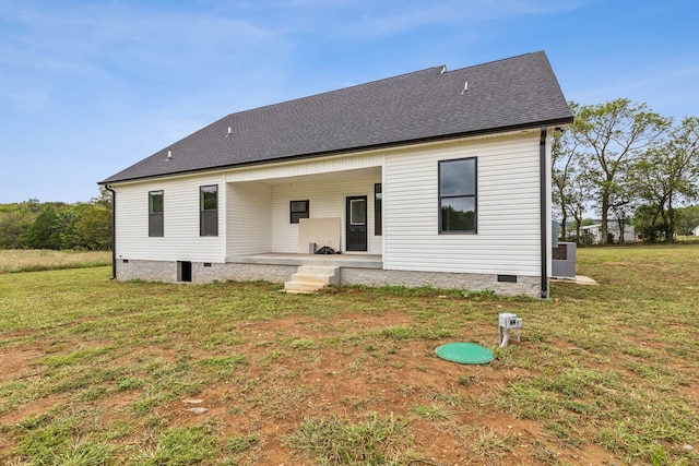 back of property featuring a lawn