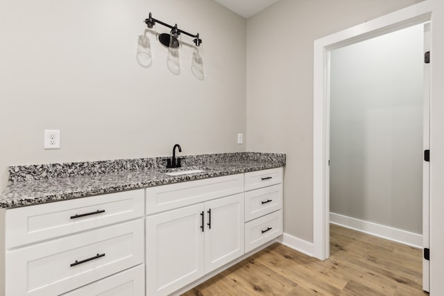 bathroom featuring vanity and hardwood / wood-style floors