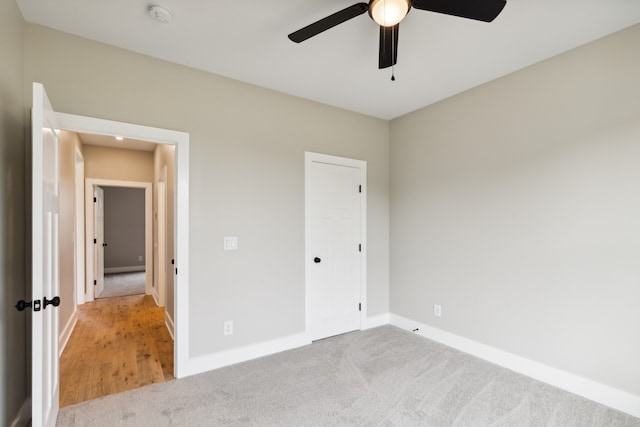 unfurnished bedroom with light carpet and ceiling fan