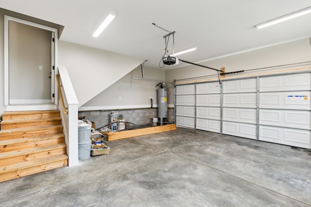 garage with gas water heater and a garage door opener