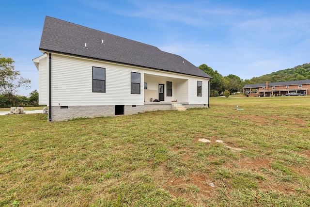 rear view of property with a yard