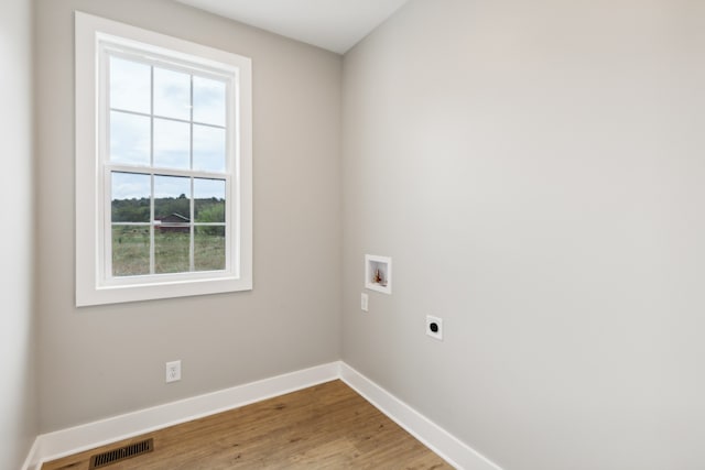 washroom with washer hookup, electric dryer hookup, and hardwood / wood-style floors