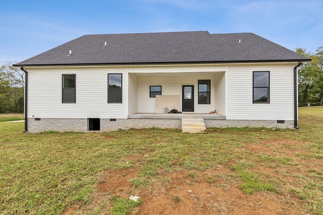 rear view of house featuring a yard