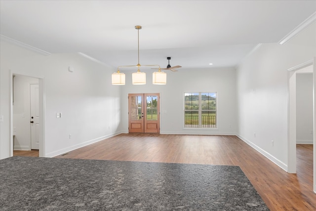 unfurnished living room featuring hardwood / wood-style flooring and crown molding