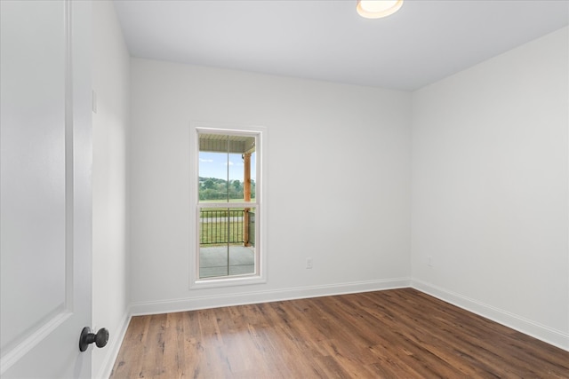 unfurnished room with hardwood / wood-style flooring