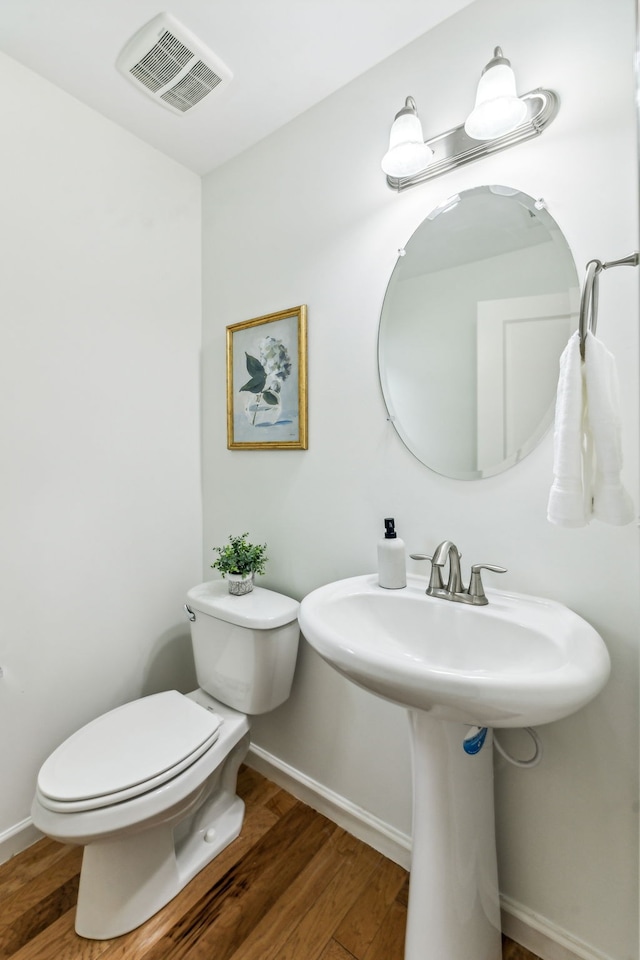 bathroom with sink, hardwood / wood-style flooring, and toilet