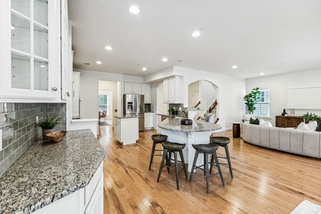 dining area featuring a fireplace, plenty of natural light, and light hardwood / wood-style flooring