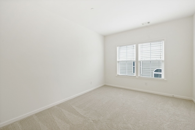 empty room featuring light carpet