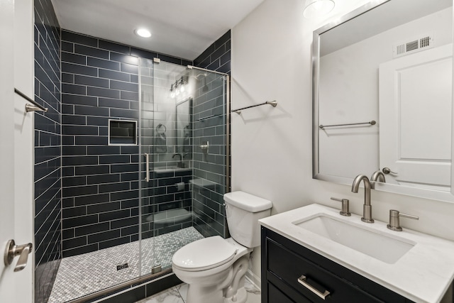 bathroom with vanity, toilet, and an enclosed shower