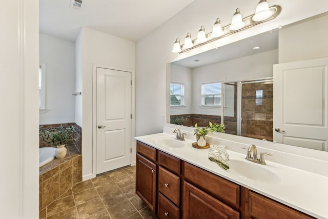 bathroom featuring vanity, plus walk in shower, and tile patterned flooring