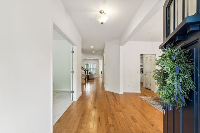 corridor with light hardwood / wood-style floors