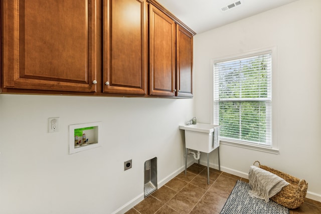 laundry room with washer hookup, cabinets, hookup for an electric dryer, and tile patterned floors