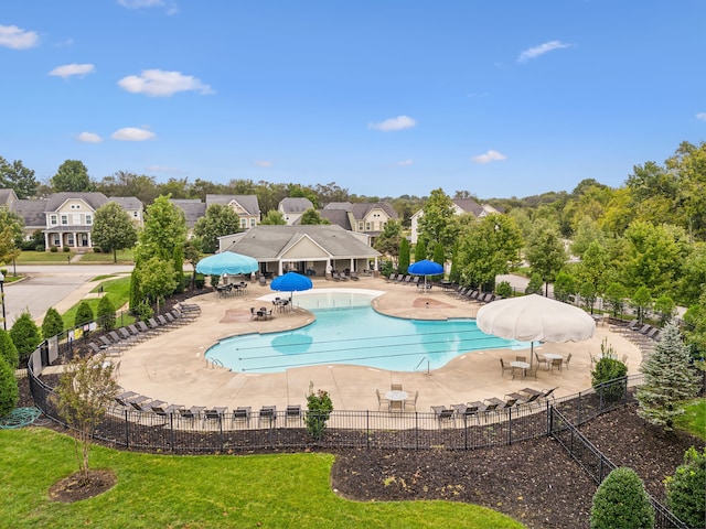 view of swimming pool featuring a patio and a yard