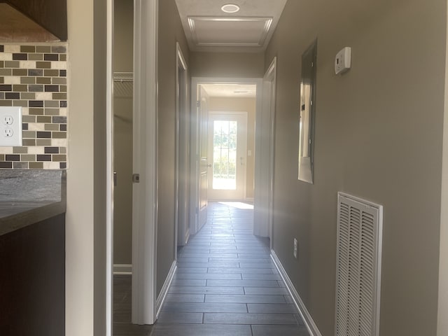 corridor with dark hardwood / wood-style flooring