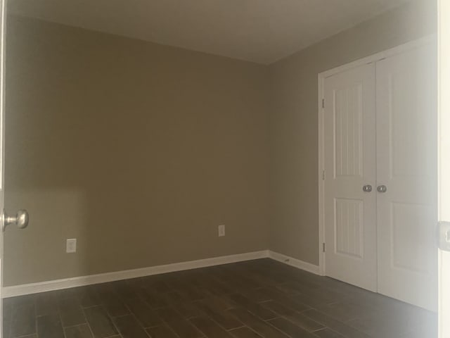 unfurnished room with dark hardwood / wood-style floors