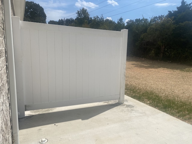 view of gate featuring a patio area