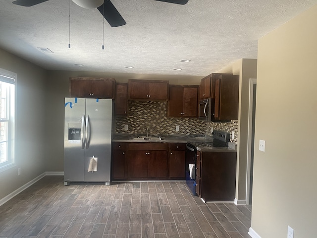 kitchen featuring ceiling fan, appliances with stainless steel finishes, plenty of natural light, and dark hardwood / wood-style flooring