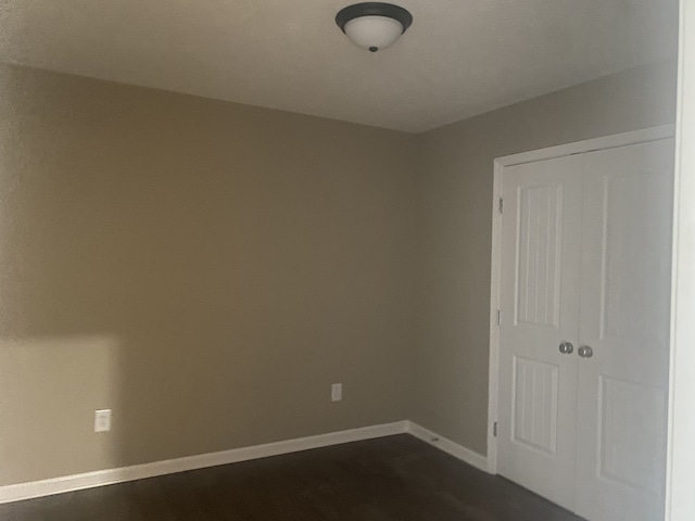 unfurnished room featuring dark hardwood / wood-style floors