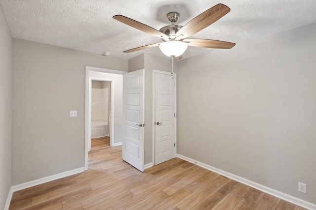 unfurnished bedroom with ceiling fan, a textured ceiling, and light hardwood / wood-style floors