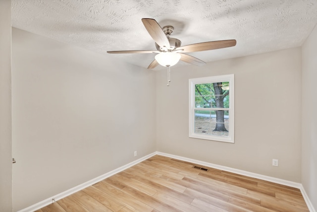 unfurnished room with a textured ceiling, ceiling fan, and light hardwood / wood-style flooring