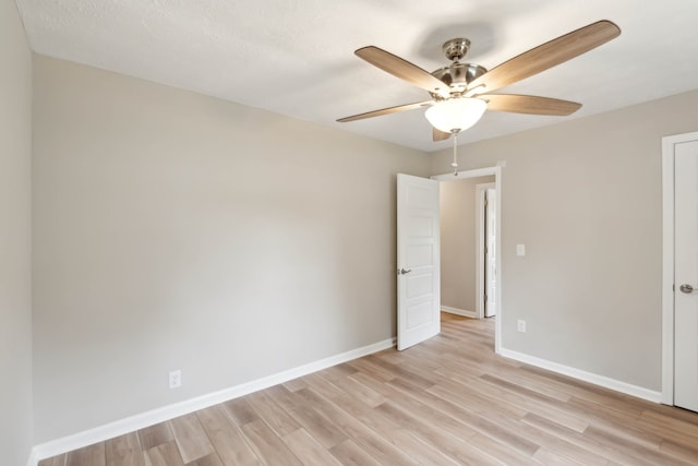 unfurnished room with light wood-type flooring and ceiling fan