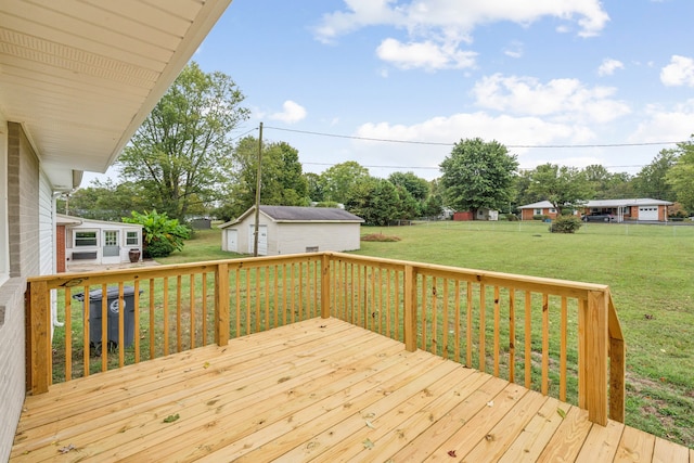 wooden terrace featuring an outdoor structure and a lawn