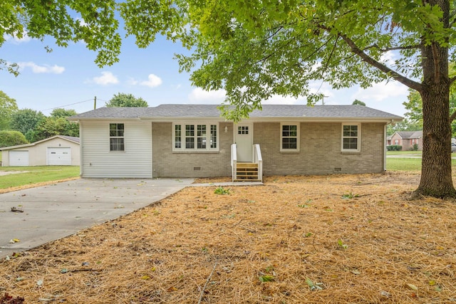 single story home with a garage and an outbuilding