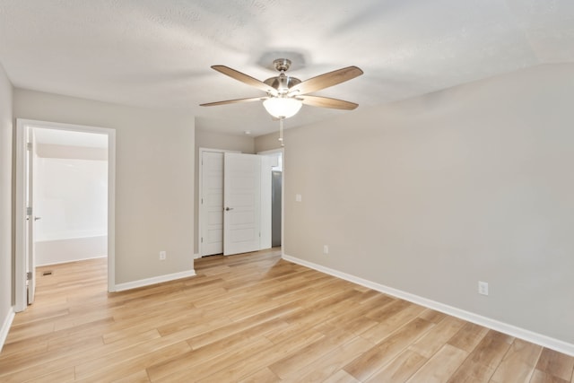 unfurnished bedroom featuring ceiling fan, a textured ceiling, light wood-type flooring, and a closet